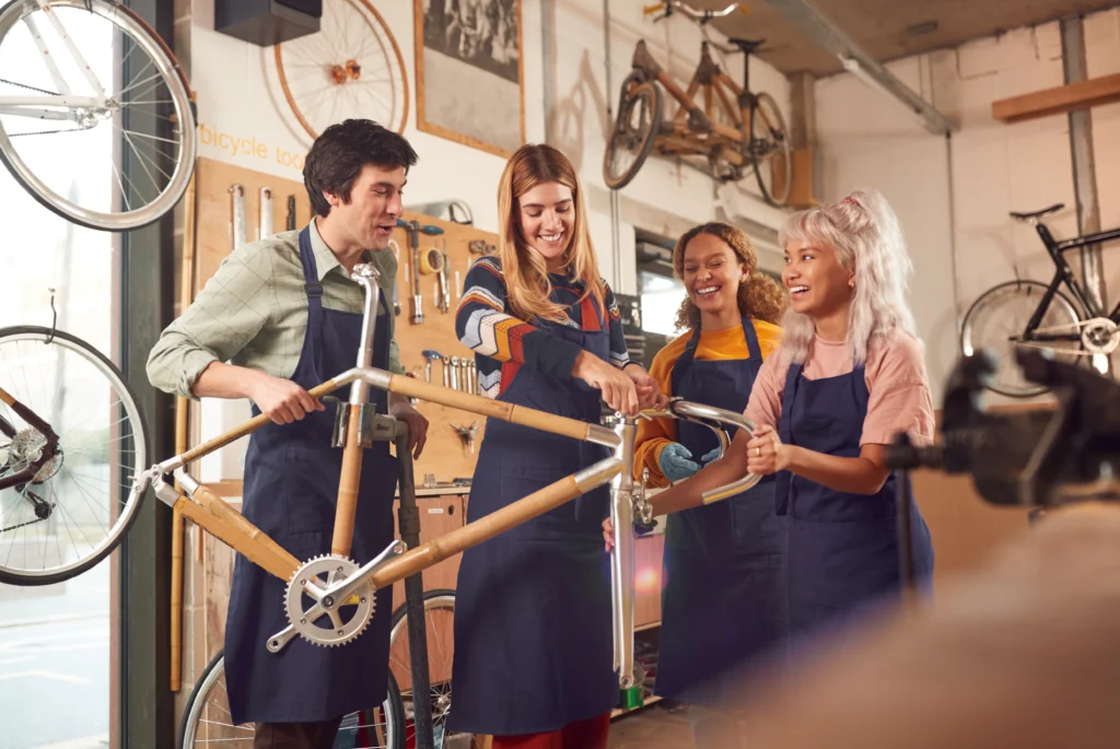Bicycle mechanics working together in a bike repair workshop