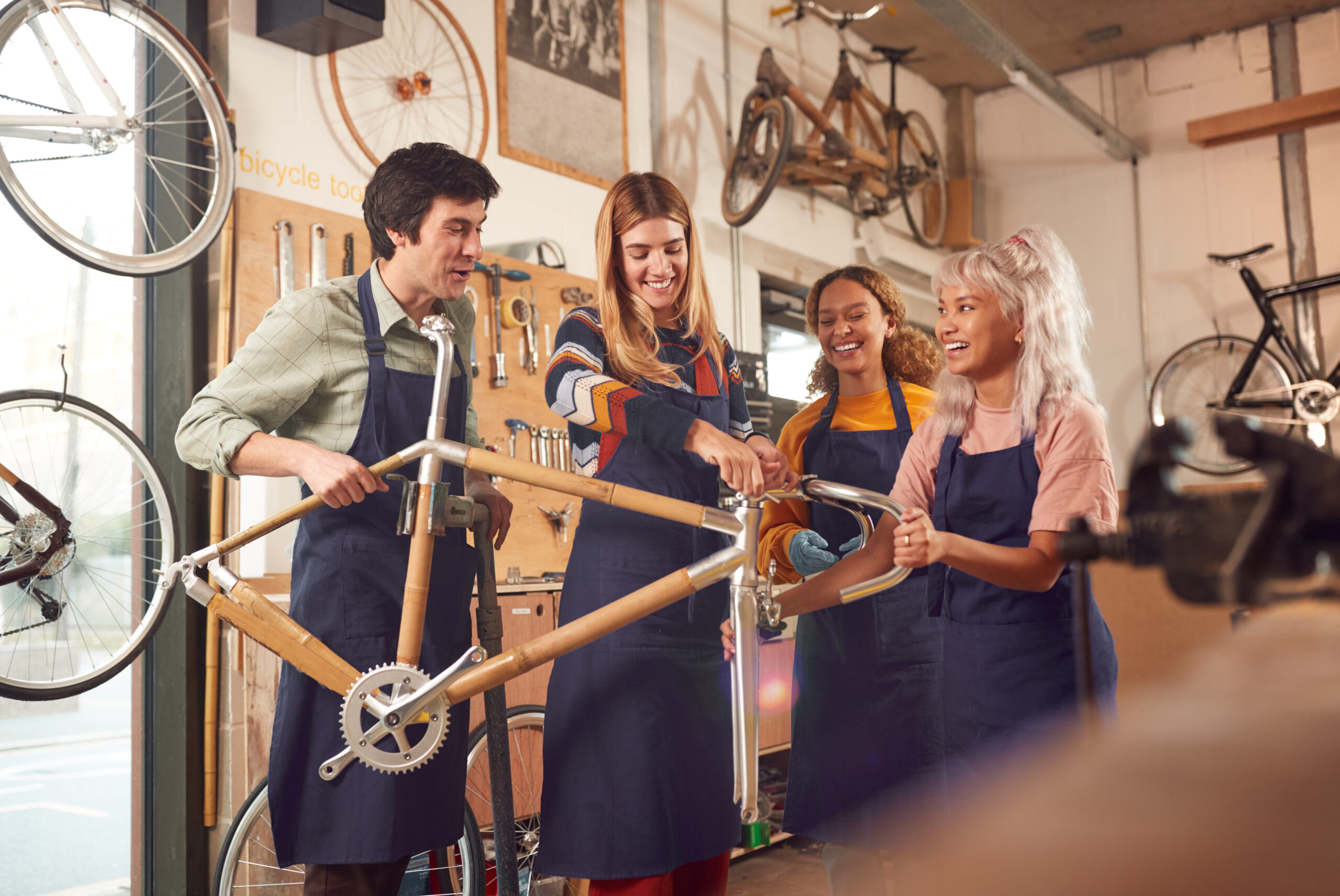 Bicycle mechanics working together in a bike repair workshop