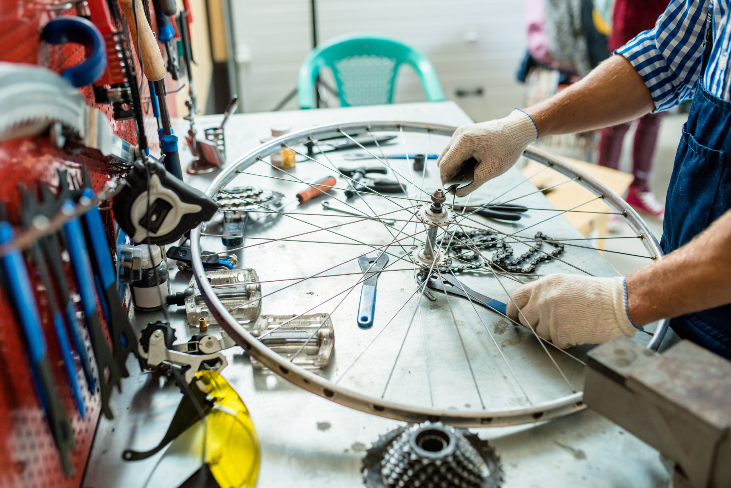 Bicycle mechanic repairing a wheel in a professional bike repair workshop