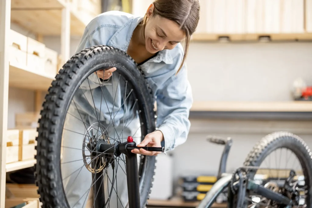 Handywoman repairing a bicycle in the workshop